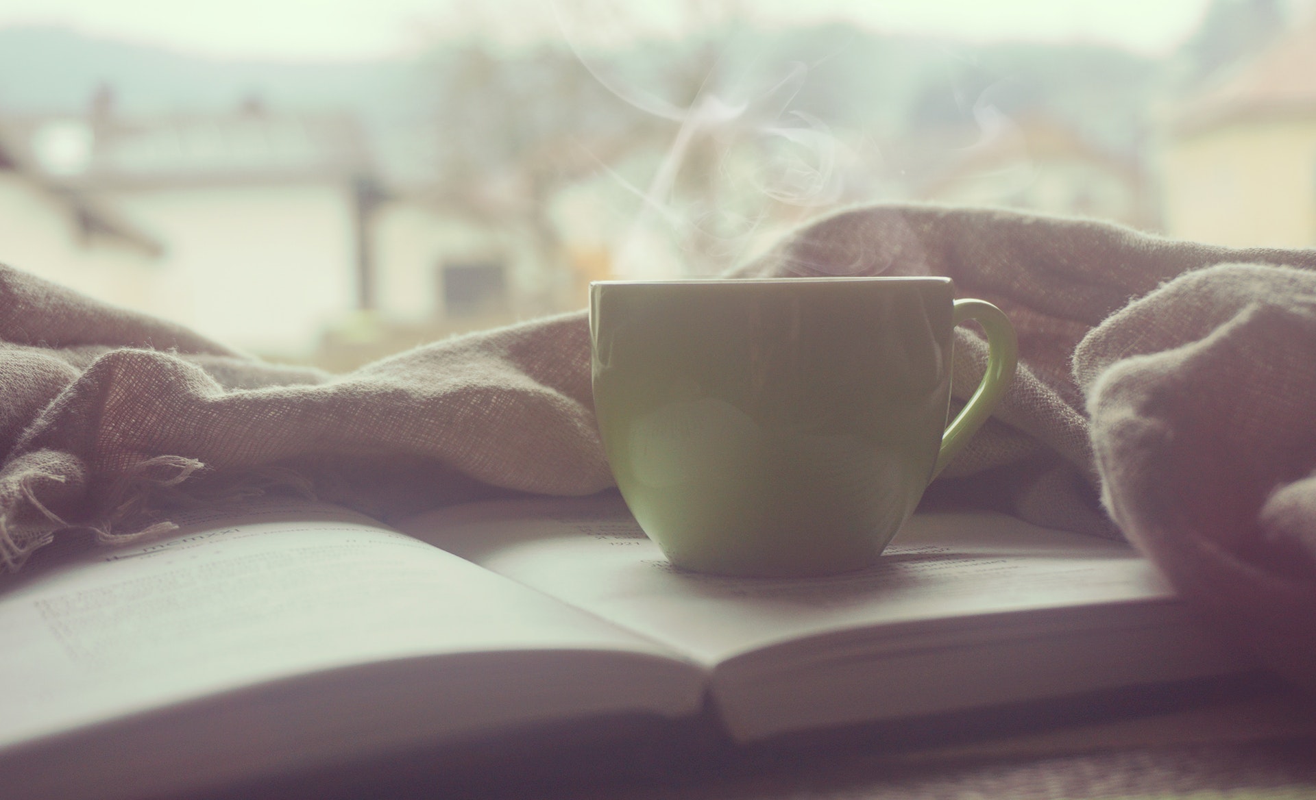 Coffee cup near book