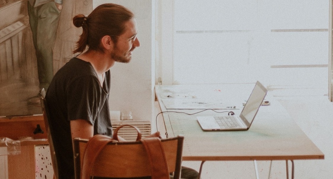 Man sitting in chair at computer